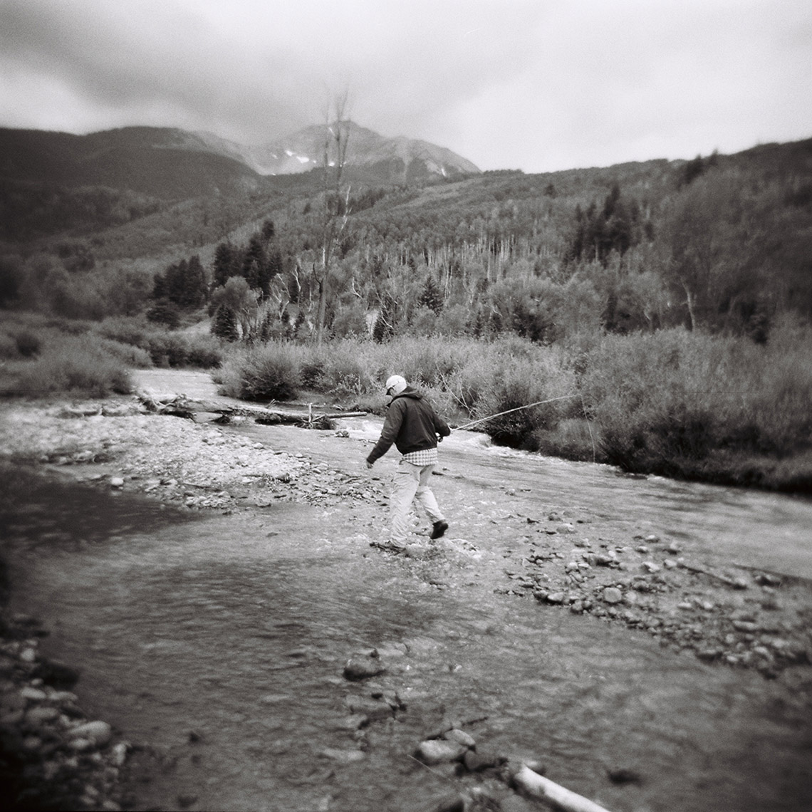man fishing in mountains 